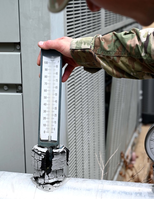 a man checks a temperature gauge