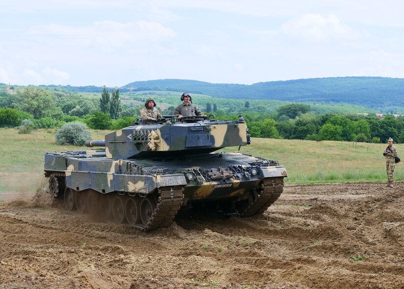 Maj. Gen. John C. Harris Jr. (left), Ohio adjutant general, rides in a Hungarian Defence Forces Leopard 2A4 battle tank during an infantry brigade presentation and showcase event June 9, 2022, in Tata, Hungary.