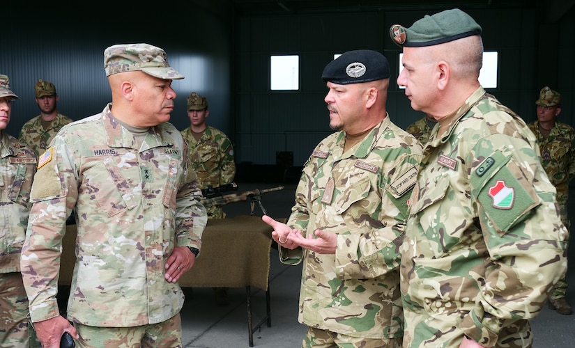 Maj. Gen. John C. Harris Jr. (from left), Ohio adjutant general, discusses weapons systems and capabilities with Brig. Gen. Gábor Lőrincz, commander of the Hungarian Defence Forces’ 25th Infantry Brigade, and Brig. Gen. Zoltán Apáti, HDF deputy commander, during an infantry brigade presentation and showcase event June 9, 2022, in Tata, Hungary.