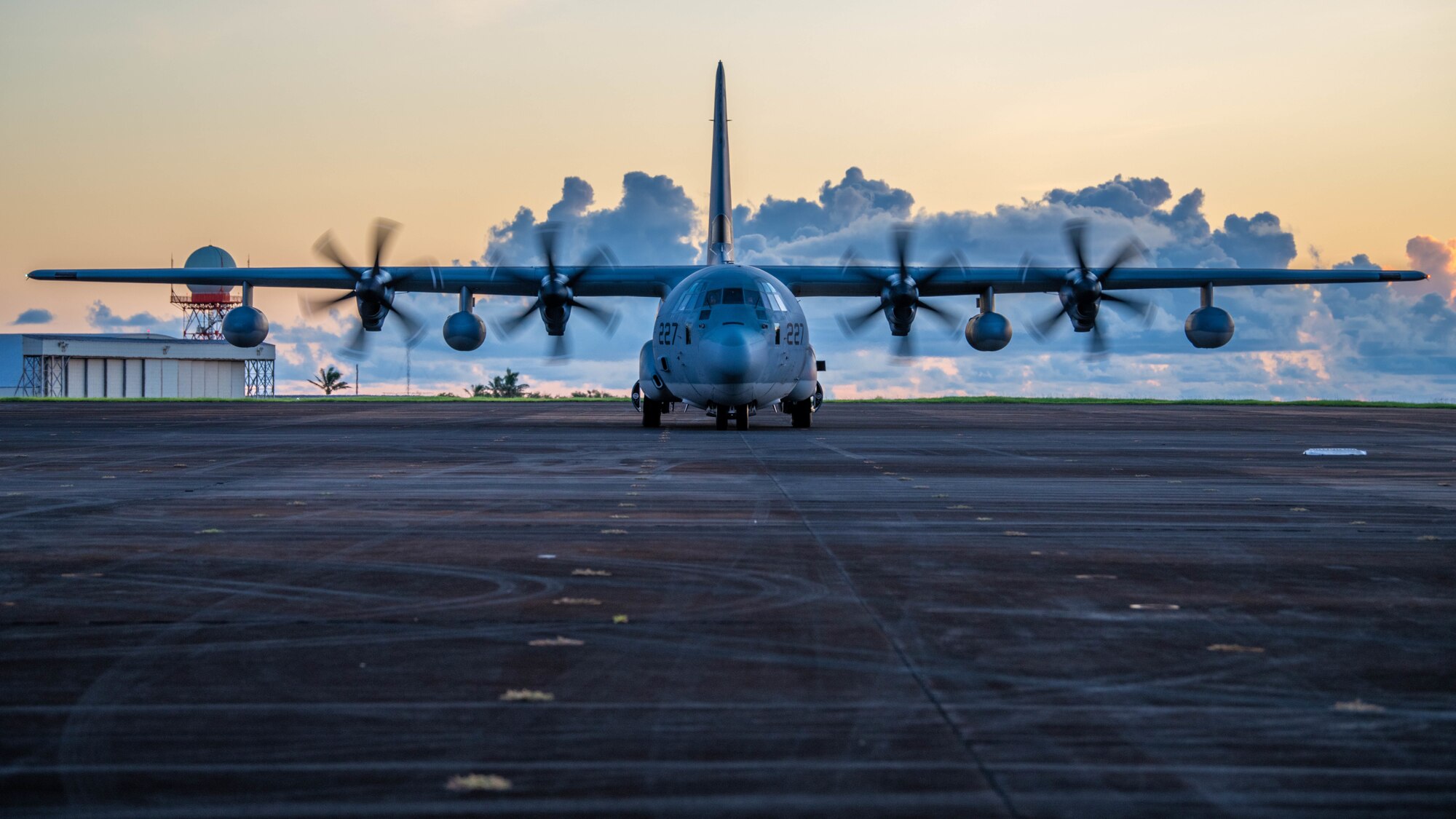 A C-130J Super Hercules sits on a flightline