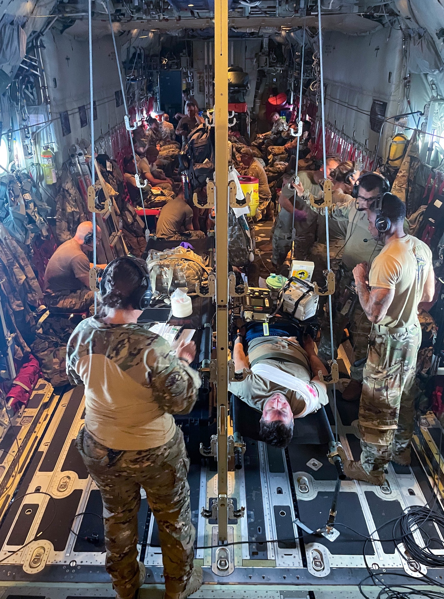 920th Aeromedical Staging Squadron, 315th Aeromedical Evacuation Squadron, and 943rd Rescue Group Airmen perform unregulated patient movement and intubation training in an HC-130J Combat King II during exercise Distant Horizon Aug. 6, 2022. Distant Horizon is an exercise designed to validate tactics, techniques, and procedures of personnel recovery and agile combat employment in the Indo-Pacific region. (U.S. Air Force photo by Staff Sgt. Darius Sostre-Miroir)