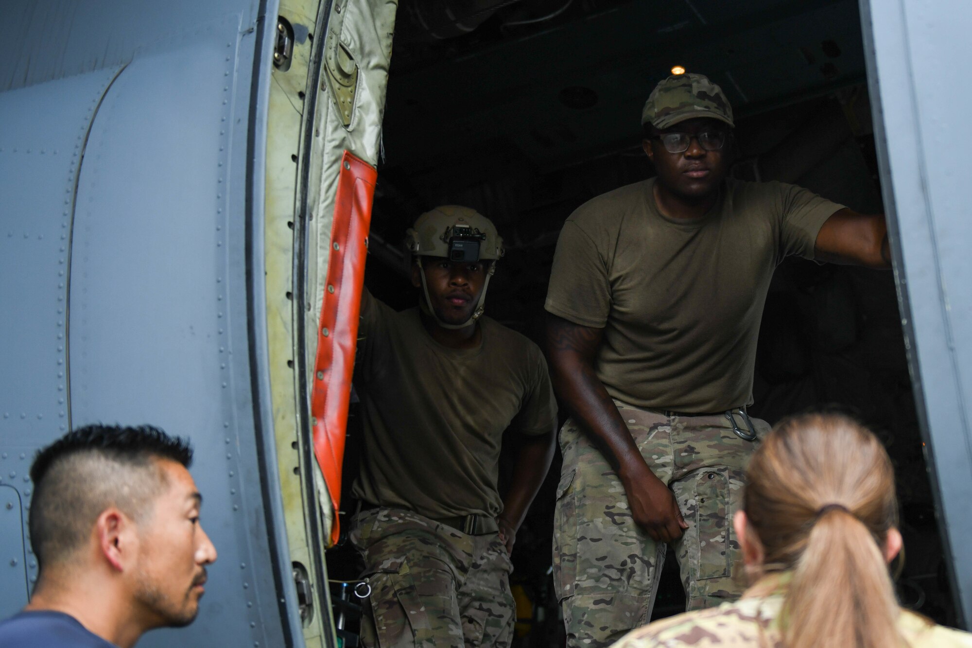 Airmen listen to a safety briefing aboard a C-130J Super Hercules