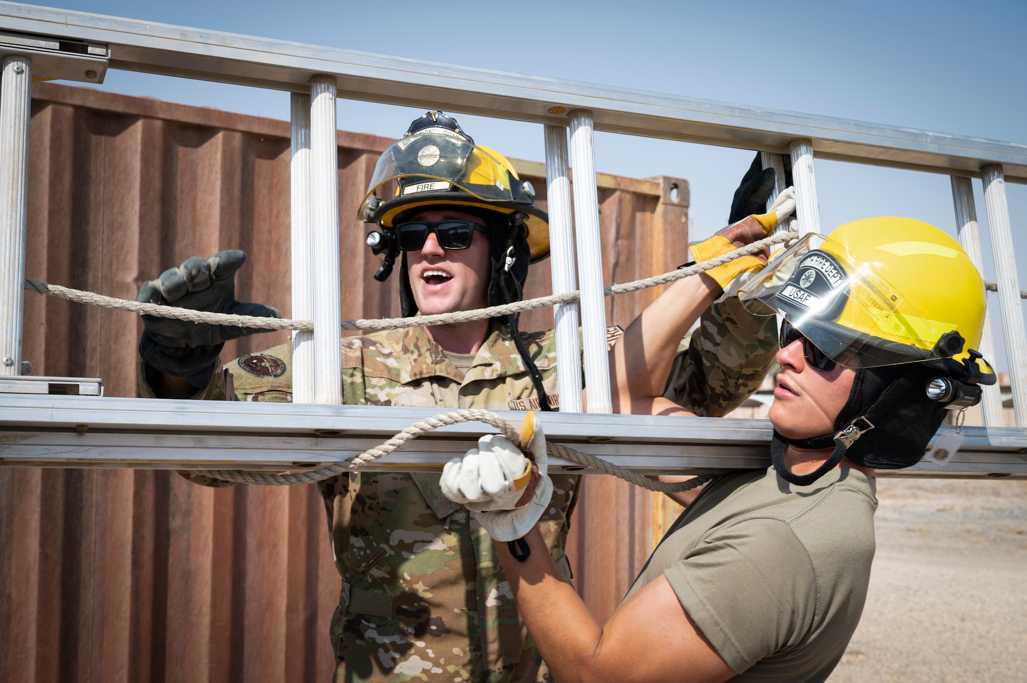 U.S. Air Force Staff Sgt. Nicholas Tafanelli, 386th Expeditionary Civil Engineer Squadron fire protection, conducts ladder training with Airman Abraham Guzman, 386th ECES fire protection, at Ali Al Salem Air Base, Kuwait, August 7, 2022. Thankful for the opportunities and mentorship he has received throughout his career, Tafanelli makes it his personal mission to pass on the knowledge to others. (U.S. Air Force photo by Staff Sgt. Dalton Williams)