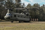 Airmen assigned to the New York Air National Guard’s 274th Air Support Operations Squadron based in Syracuse, part of the 107th Attack Wing board a CH-47F Chinook helicopter from the New York National Guard’s Bravo Company, 3rd Battalion, 126th Aviation, during a tactical air control party training procedure in Upstate New York, Aug. 7, 2022. The training was a part of an operation run by the Air Force Research Lab to test experimental technology and its uses in tactical situations.