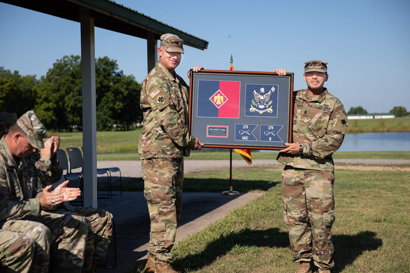 Command Sgt. Maj. Chris Murray presents Col. Colby Wyatt, outgoing commander of the 45th Infantry Brigade Combat Team, Oklahoma National Guard, with the Meritorious Service Medal during a change of command ceremony, Camp Gruber Training Center, Okla., Aug. 14, 2022. Wyatt served as the commander of the 45th IBCT for three years and relinquished command to Col. Andrew Ballenger. (Oklahoma Army National Guard photo by Spc. Danielle Rayon)