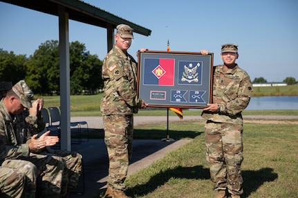 Command Sgt. Maj. Chris Murray presents Col. Colby Wyatt, outgoing commander of the 45th Infantry Brigade Combat Team, Oklahoma National Guard, with the Meritorious Service Medal during a change of command ceremony, Camp Gruber Training Center, Okla., Aug. 14, 2022. Wyatt served as the commander of the 45th IBCT for three years and relinquished command to Col. Andrew Ballenger. (Oklahoma Army National Guard photo by Spc. Danielle Rayon)