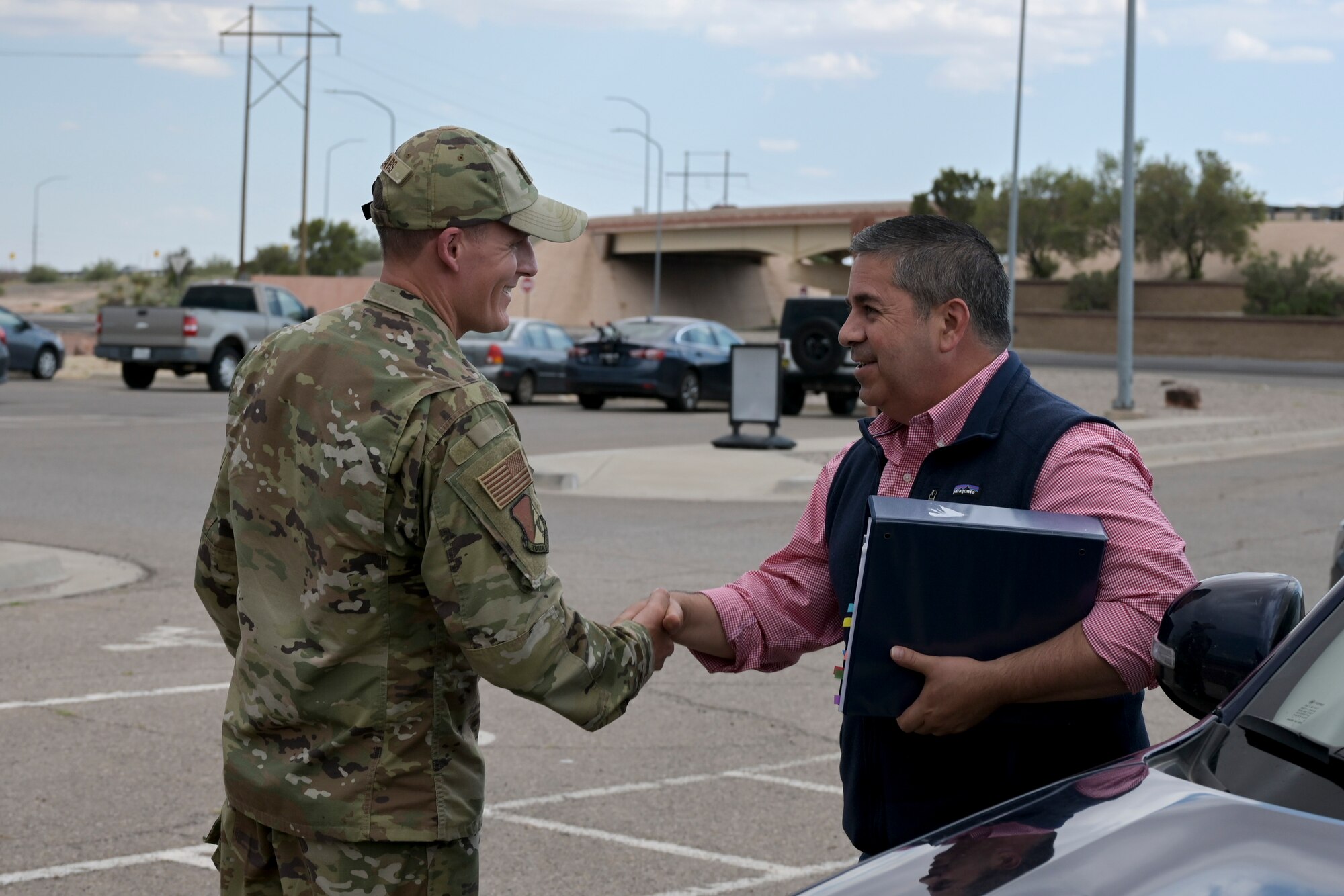 Col. Justin Spears, 49th Wing commander, greets Sen. Ben Ray Lujan as he arrives at Holloman Air Force Base, New Mexico, August 15, 2022. Lujan visited Holloman to learn about the 49th Wing and mission partner operations. (U.S. Air Force photo by Airman 1st Class Antonio Salfran)