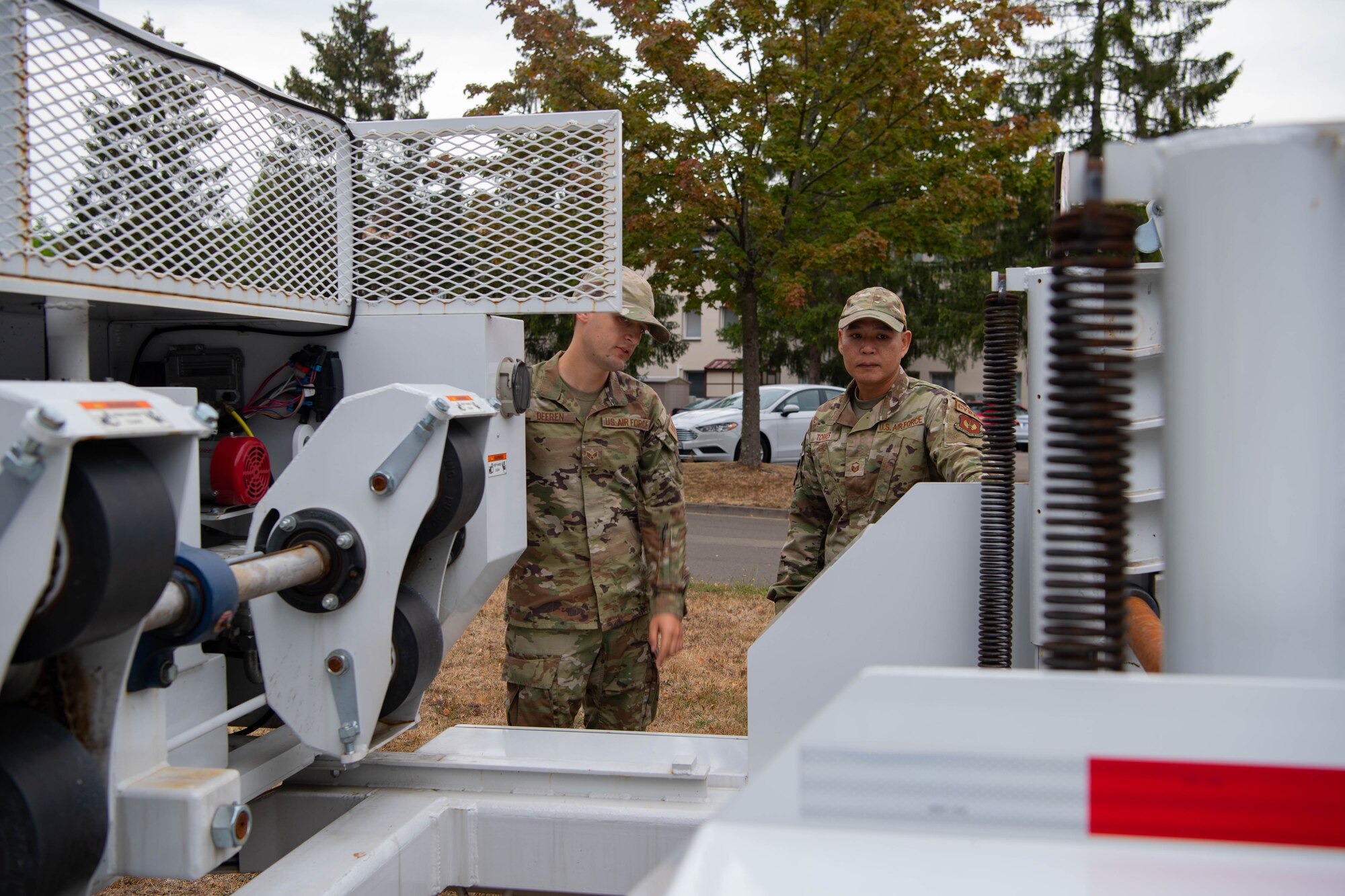 U.S. Air Force Master Sgt. Cyrus Torres, Left, 1st Communications Maintenance Squadron vehicle maintenance section chief, and Senior Airman Benjamin Deeren, 1st CMXS vehicle maintenance technician, operate a vehicle during an open house at Kapaun Air Station, Germany, Aug. 17, 2022.