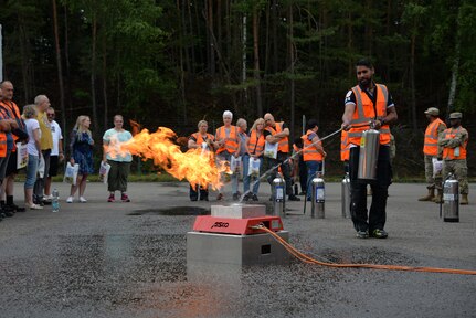 Florian Krause, distribution and transportation safety representative at the U.S. Army Medical Materiel Center-Europe, shows off his skills with the practice fire extinguisher exercise provided by the Rhienland-Pfalz Garrison Fire Department.