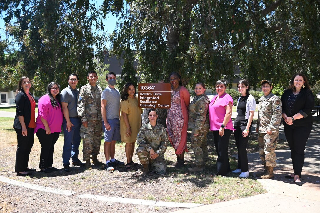 Staff from the Sexual Assault Prevention and Response Office and the Domestic Abuse Victim Advocate, Violence Prevention Integrator, Community Support Coordinator, Diversity, Equity, Inclusion, and Accessibility office, Civilian Health Promotions office, and satellite offices for the Equal Opportunity, Religious Support Team, and Victim’s Council poses for a photo in front of their new integrated response co-location pilot program located at Hawk’s Cove on Vandenberg Space Force Base, Calif., July 19, 2022. (U.S. Space Force photo by Airman 1st Class Kadielle Shaw)