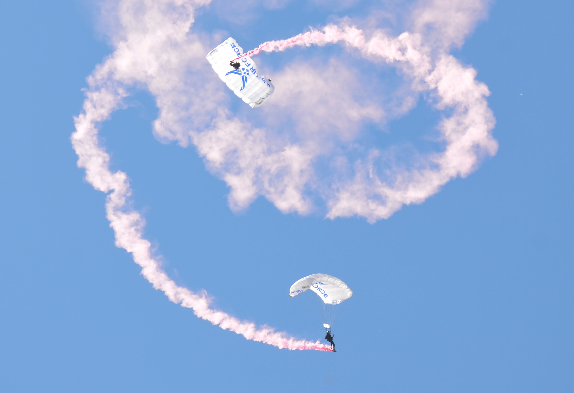 Members of the United States Air Force Academy's Wings of Blue Parachute Team stream down from the sky at the Heritage to Horizon Air Show at Maxwell Air Force Base