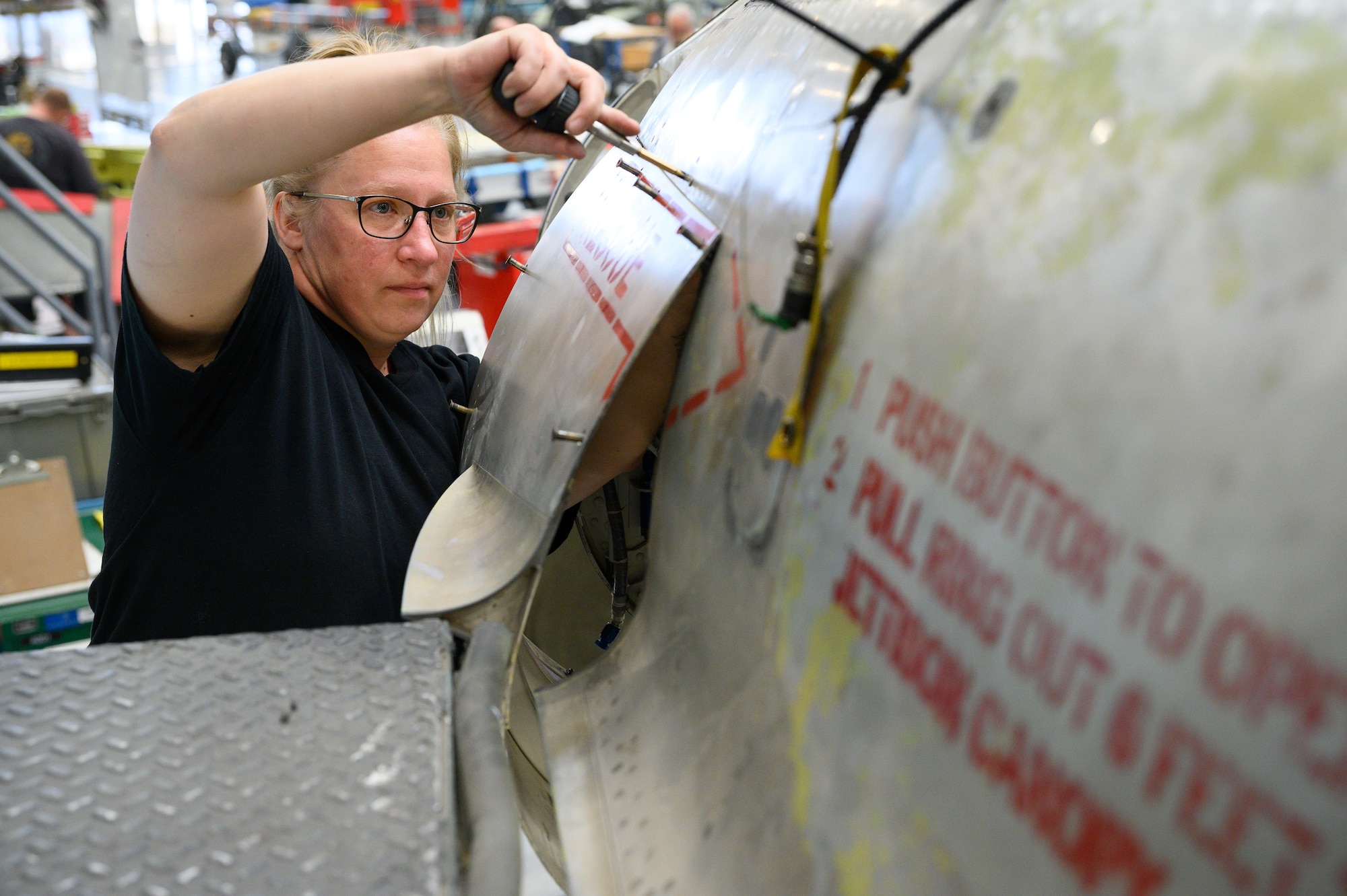 Brandy Stewart, 573rd Aircraft Maintenance Squadron, installs a door panel onto an F-16 Fighting Falcon undergoing a Service Life Extension Program work package at Hill Air Force Base, Utah, Aug. 4, 2022.