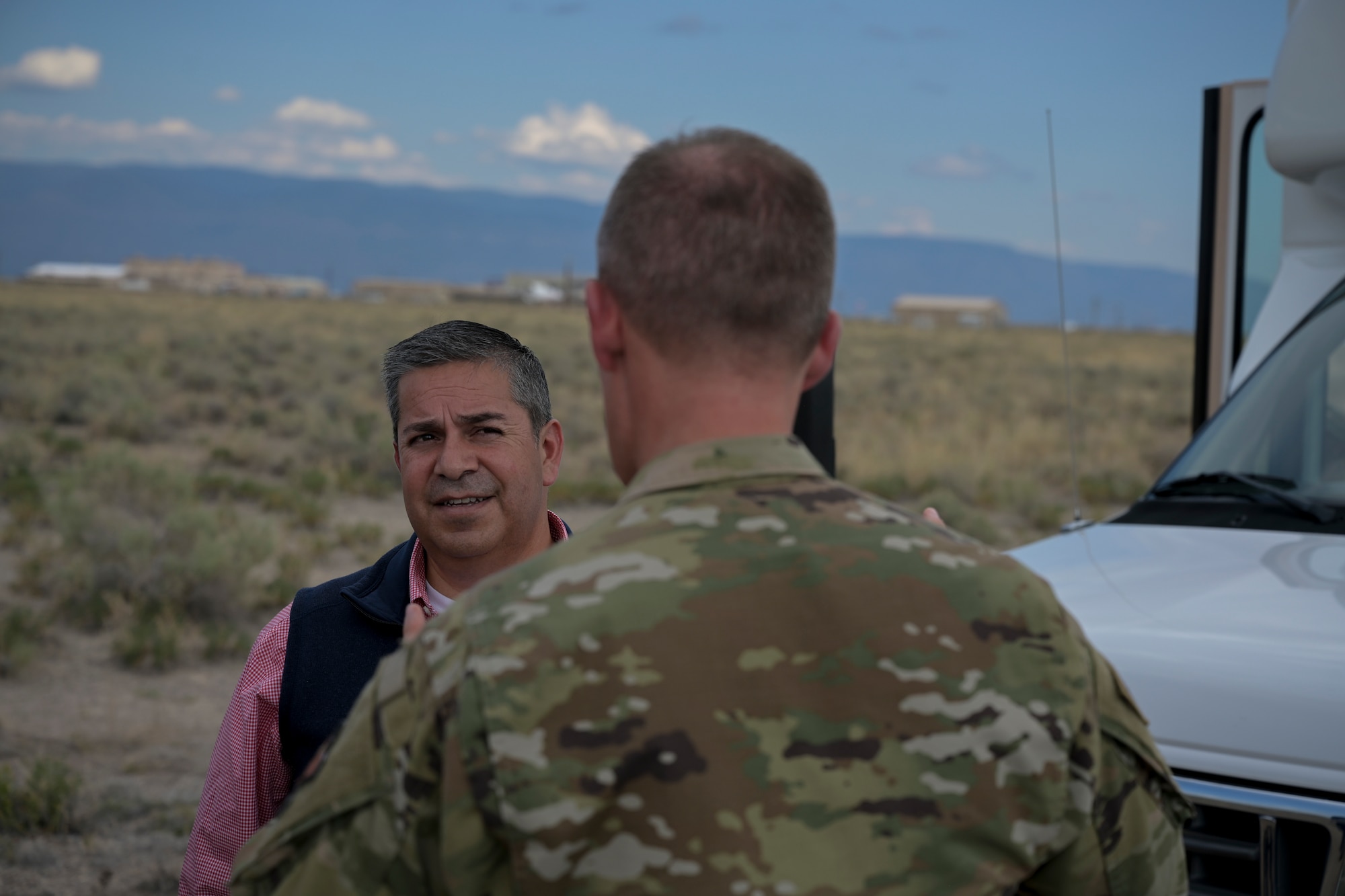Sen. Ben Ray Lujan, of New Mexico, speaks with Col. Justin Spears, 49th Wing commander, upon arrival to the Holloman High Speed Test Track on Holloman Air force Base, New Mexico, August 15, 2022. HHSTT is the world’s premier rocket sled test track. (U.S. Air Force photo by Airman 1st Class Antonio Salfran)