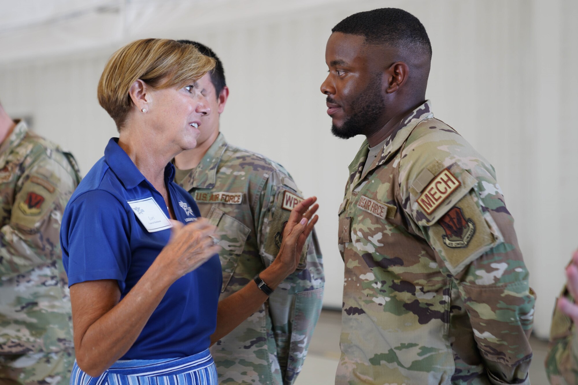 Retired female general talking to enlisted Airman.