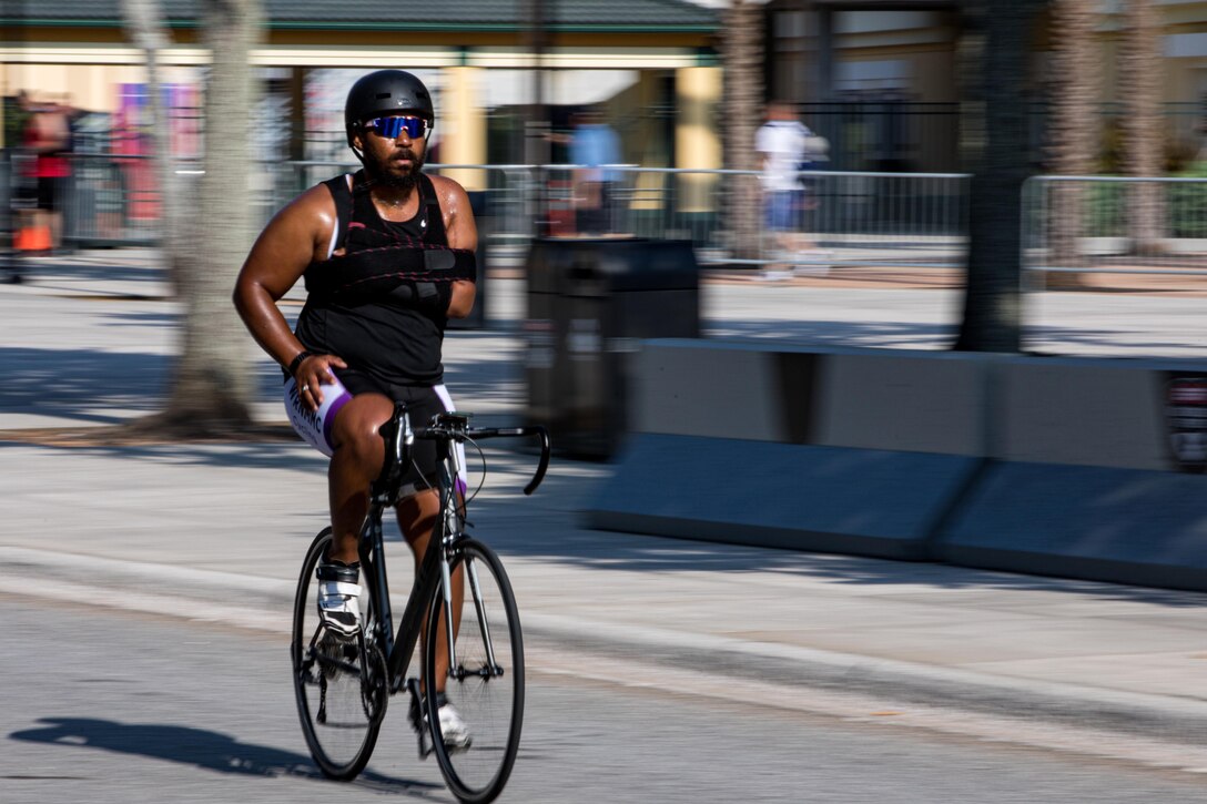 A veteran cycles along a street.