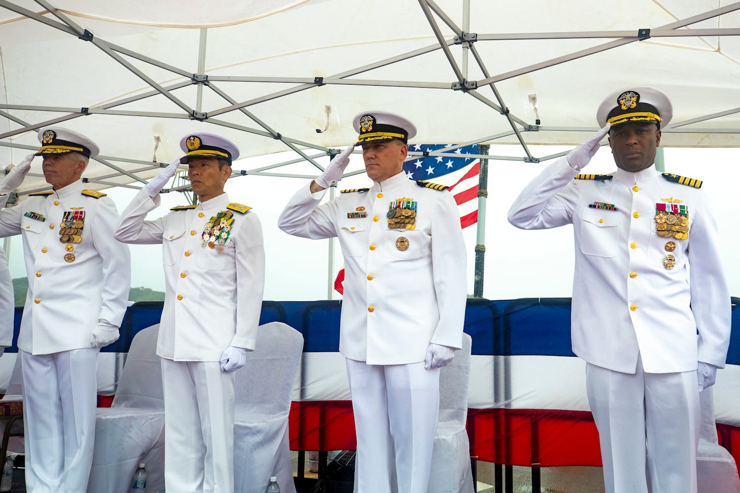 YOKOSUKA, Japan (Aug. 18, 2022) Vice Adm. Karl Thomas, commander, U.S. 7th Fleet, Vice Adm. FUKUDA Tatsuya, commander, Fleet Escort Force, Japan Maritime Self-Defense Force (JMSDF), Capt. Chase Sargeant, outgoing commander, Task Force 71 and Capt. Walter Mainor, incoming commander, Task Force 71, salute during the playing of the national anthem during Commander, Task Force (CTF) 71/Destroyer Squadron (DESRON) 15 change of command ceremony aboard Arleigh Burke-class guided-missile destroyer USS Benfold (DDG 65) pierside at Commander, Fleet Activities Yokosuka, Aug. 18. Commander, Task Force (CTF) 71/Destroyer Squadron (DESRON) 15 is the Navy’s largest forward-deployed DESRON and the U.S. 7th Fleet’s principal surface force. (U.S. Navy photo by Mass Communication Specialist 3rd Class RuKiyah Mack)