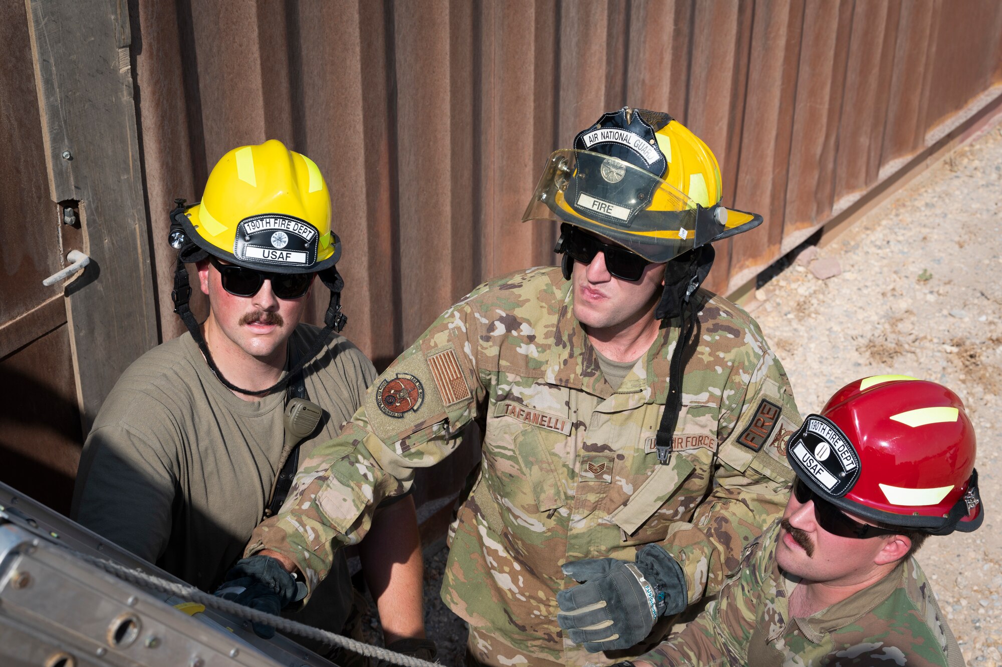 From left, U.S. Air Force Staff Sgt. Colton Stark, 386th Expeditionary Civil Engineer Squadron fire protection, Staff Sgt. Nicholas Tafanelli, 386th ECES fire protection, and Tech. Sgt. Christopher Welch, 386th ECES station captain, walkthrough ladder training at Ali Al Salem Air Base, Kuwait, August 7, 2022. Using the experiences and skills he has received throughout his career and in the Topeka Fire Department, he has worked with the team to craft training covering new techniques and tactics in the fire protection career field. Tafanelli was recently recognized at the United Service Organizations Service Member of the Year award for responding to 318 emergencies, including 61 fires and 128 motor vehicle accidents as a firefighter in Topeka, Kansas. (U.S. Air Force photo by Staff Sgt. Dalton Williams)