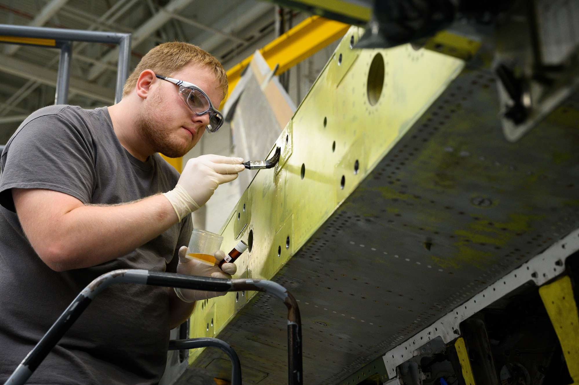 Brayden Kilvang, 573rd Aircraft Maintenance Squadron, prepares a wing attachment surface on an F-16 Fighting Falcon undergoing a Service Life Extension Program work package at Hill Air Force Base, Utah, Aug. 4, 2022.