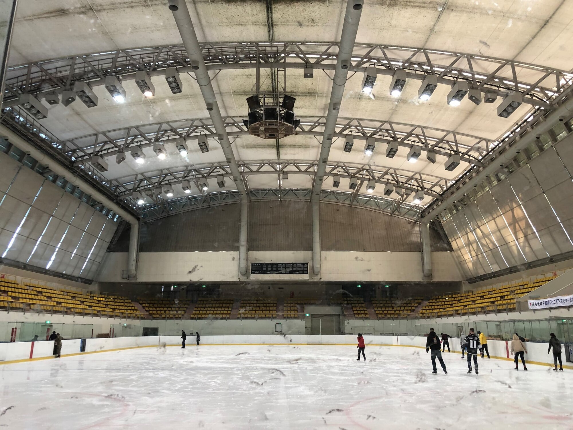 Members skate around a ice rink.