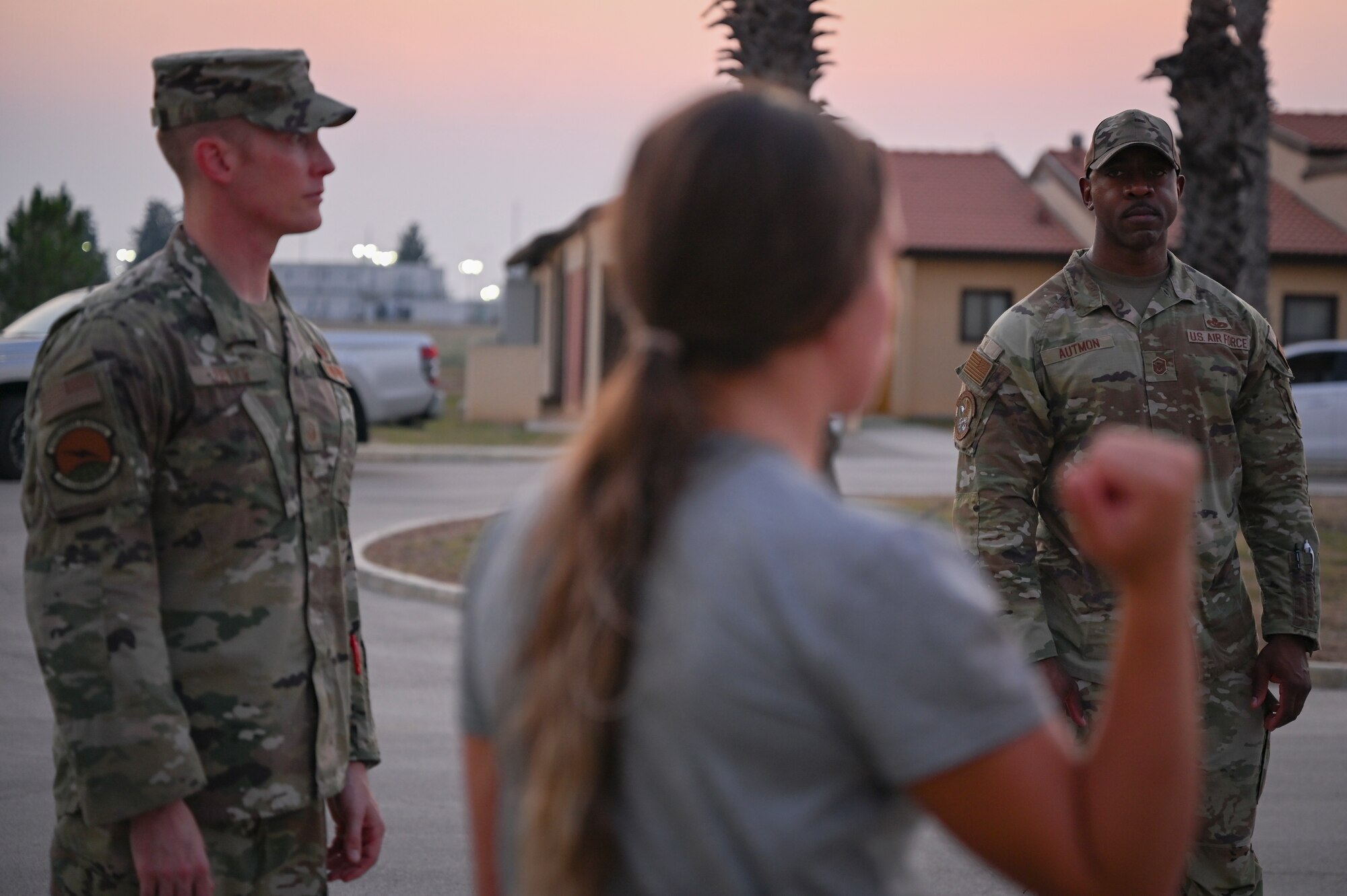 Master Sgt. Sean Fetke, First Sgt. assigned to the 39th Communications Squadron, and Master Sgt. Cory Autmon, Frist Sgt. assigned to the 39th Security Forces Squadron, debrief Tech Sgt. Michaela Boles, noncommissioned officer in charge of fitness and sports assigned to the 39th Force Support Squadron, after assessing her response skills during a real-world exercise scenario as part of training for the First Sergeant symposium at Incirlik Air Base, Turkey, August 4, 2022. The training consisted of three scenarios the attendees might respond to while acting as a first sergeant. The purpose of this event was to teach additional duty first sergeants what it means to fill the role and share knowledge with those who might be interested in wearing a diamond of their own one day. (U.S. Air Force photo by Staff Sgt. Gabrielle Winn)
