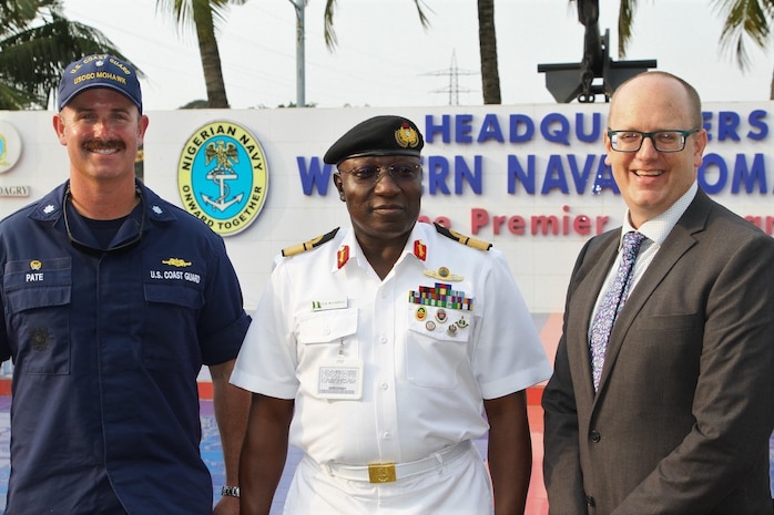 Cmdr. Andrew Pate, commanding officer of the Famous-class medium endurance cutter USCGC Mohawk (WMEC 913), left, Nigerian Navy Rear Adm. Yakubu Wambai, Flag Officer Commanding of Nigeria's Western Naval Command, center, and U.S. Consul General Will Stevens pose for a photo during USCGC Mohawk’s scheduled port visit in Lagos, Nigeria, Aug. 18, 2022.