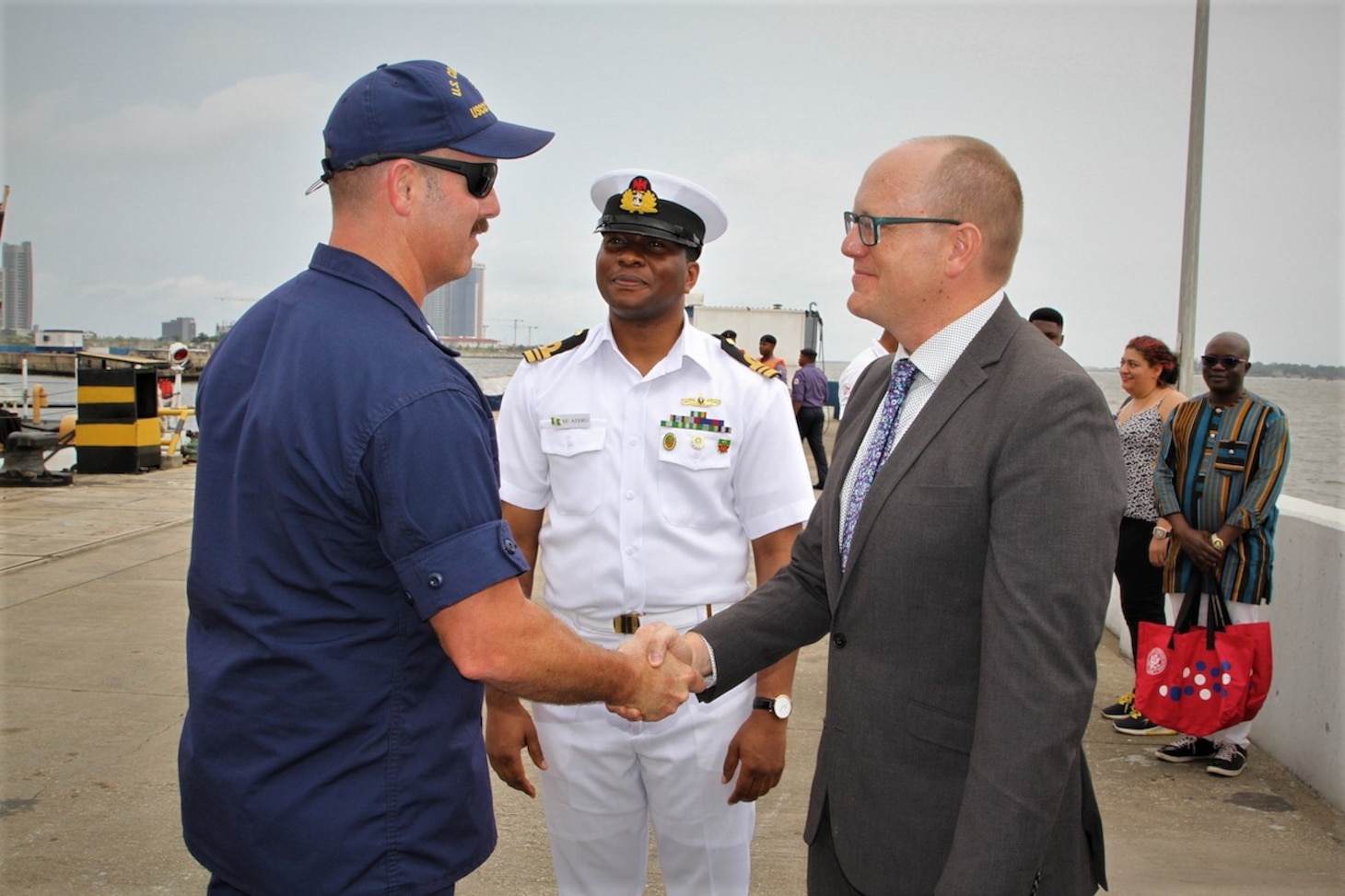 Cmdr. Andrew Pate, commanding officer of the Famous-class medium endurance cutter USCGC Mohawk (WMEC 913), left,  meets with U.S. Consul General Will Stevens, right, and Nigerian Navy Lt. Cmdr. S. Ateru, Western Navy Command liaison officer, during a scheduled port visit in Lagos, Nigeria, Aug. 18, 2022.