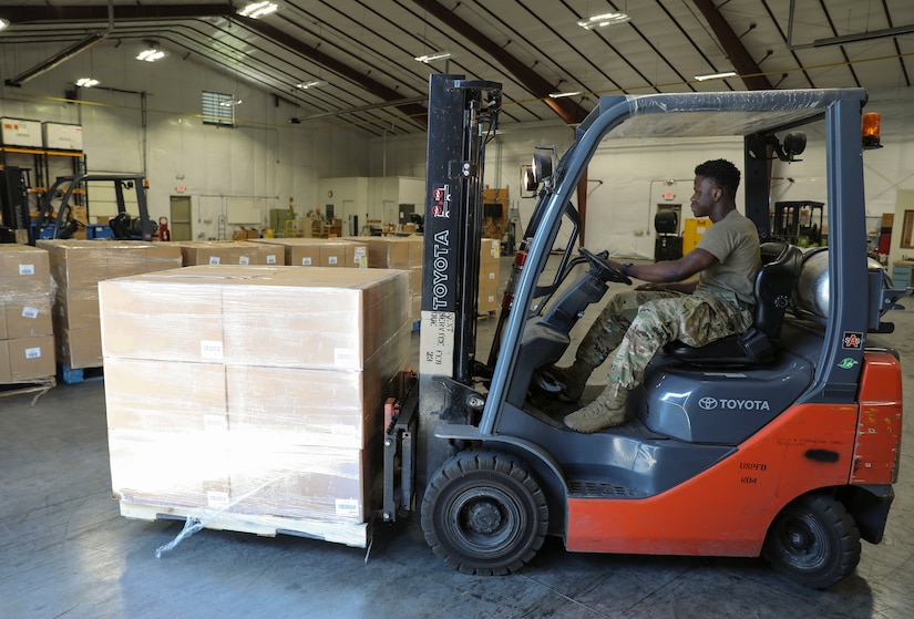 Spc. Babawale Bankole, a supply technician with United States Property and Fiscal Office (USPFO), uses a forklift to unload 12 pallets of coffee pods donated by Holy Joe’s Café to the Pennsylvania National Guard Aug. 3 at Fort Indiantown Gap, Pa. (U.S. Army National Guard photo by Sgt. 1st Class Zane Craig)