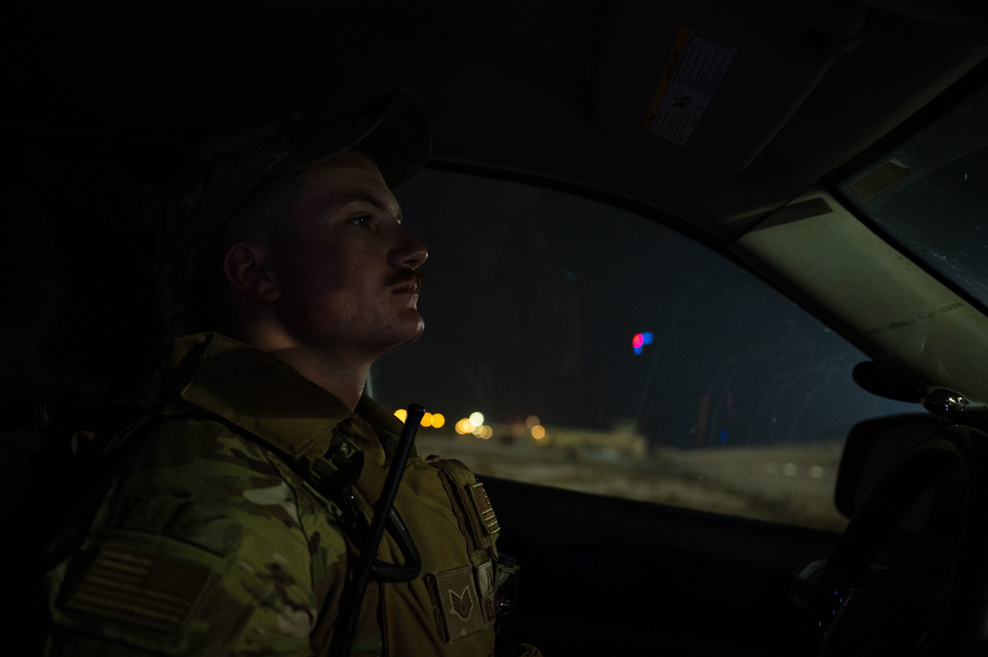U.S. Air Force Staff Sgt. Justin Pickens, a military working dog handler with the 379th Expeditionary Security Forces Squadron, drives out to patrol a section of the base perimeter with his MWD, Aug. 10, 2022 at Al Udeid Air Base, Qatar. Pickens’ patrol helped ensure there were no detectable threats on the perimeter. (U.S. Air Force photo by Staff Sgt. Dana Tourtellotte)