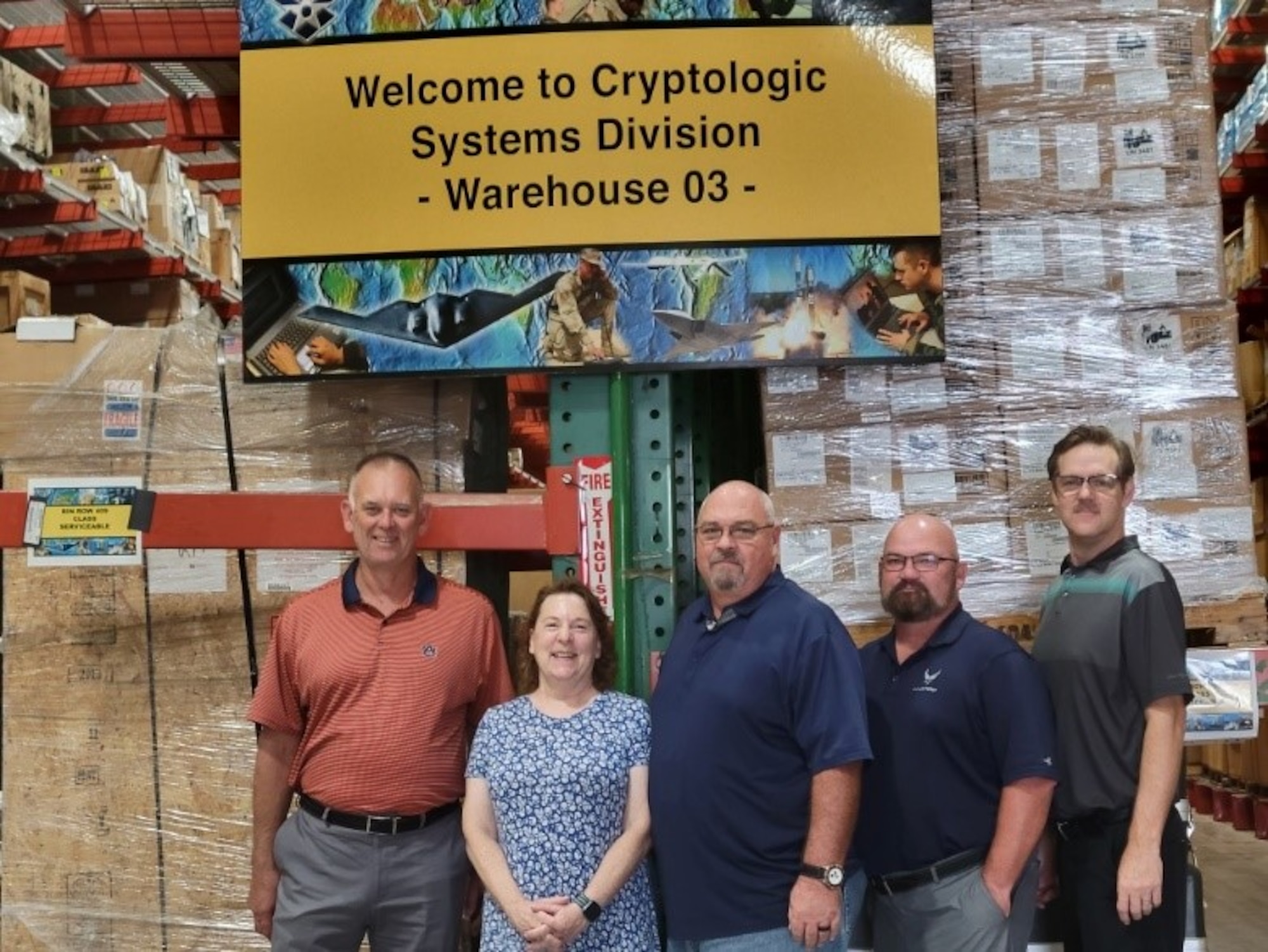 From left, Scott Hunter, ILS-S SME; Barbara Craig, CDAS Program Manager; Curt Bollinger, Chief of Inventory; Allen Pratt, ILS-S SME; and Todd Landuyt, ILS-S SME, gather at the HNC 03 Warehouse, Joint Base San Antonio-Lackland, Texas, July 28, 2022. (U.S. Air Force photo)