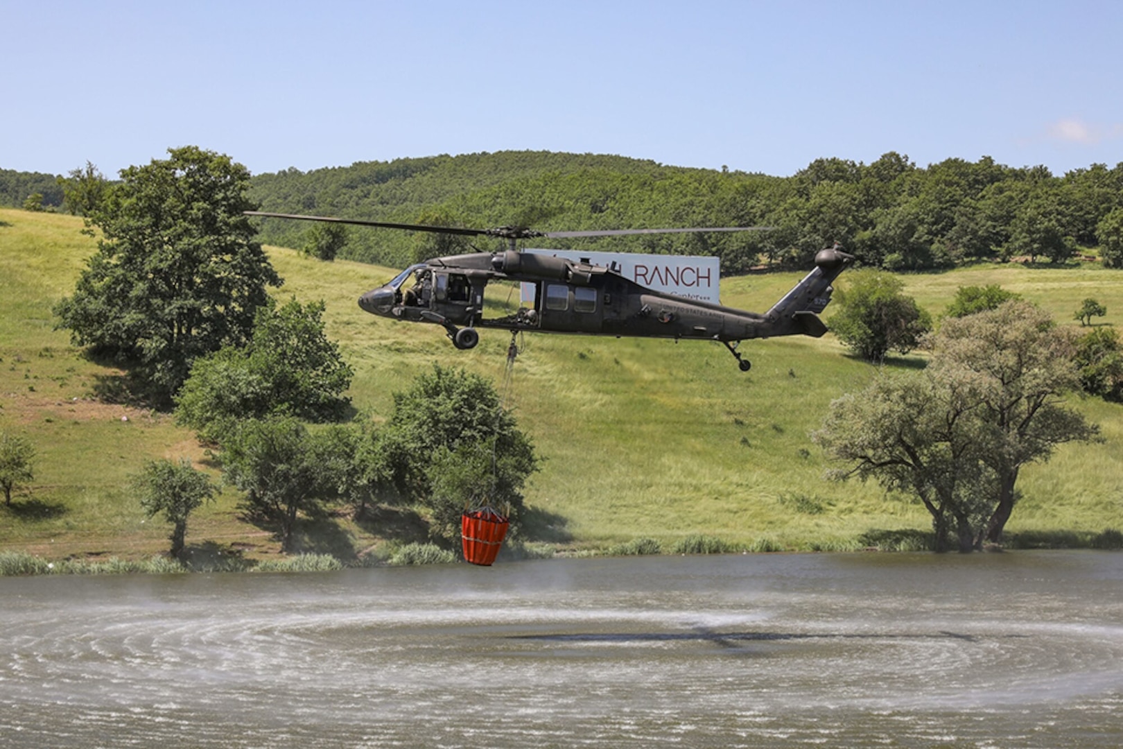 Virginia National Guard Soldiers assigned to 2nd Battalion, 224th Aviation Regiment, 29th Infantry Division conduct helicopter bucket aerial firefighting training near Gjilan, Kosovo, June 2, 2022.