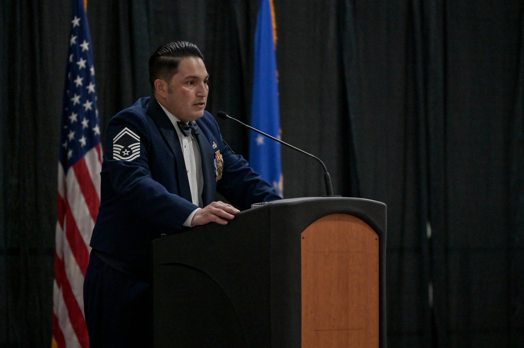 U.S. Air Force Senior Master Sgt. Humberto Conchas, 23rd Maintenance Group superintendent, gives a speech during a senior non-commissioned officer induction ceremony at the Rainwater Conference Center, Valdosta, Georgia, Aug. 12, 2022. Conchas has been a SNCO for seven years and gave the speech to the newly appointed SNCOs. The inductees have shown their strength and perseverance, and the U.S. Air Force has put their trust in these experienced and skilled Airmen, allowing them to progress to the next level. (U.S. Air Force photo by Senior Airman Rebeckah Medeiros)