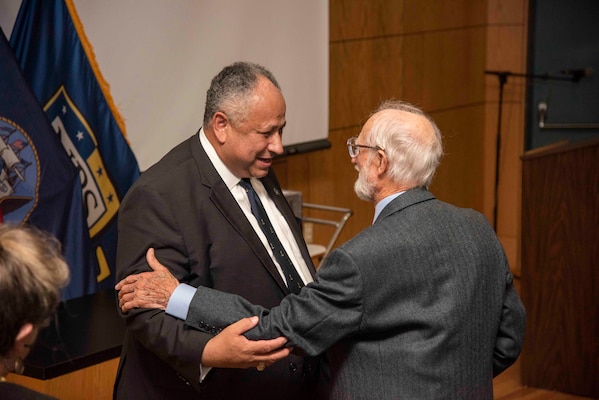 Secretary of the Navy Carlos Del Toro, left, embraces Professor Emeritus Dr. Rudy Panholzer, Del Toro's former professor and thesis advisor, during an award ceremony Aug. 18, 2022. Del Toro awarded Panholzer with the Distinguished Civilian Service Award for his life-long commitmne to the Naval Postgraduate School and to the DOD at large.