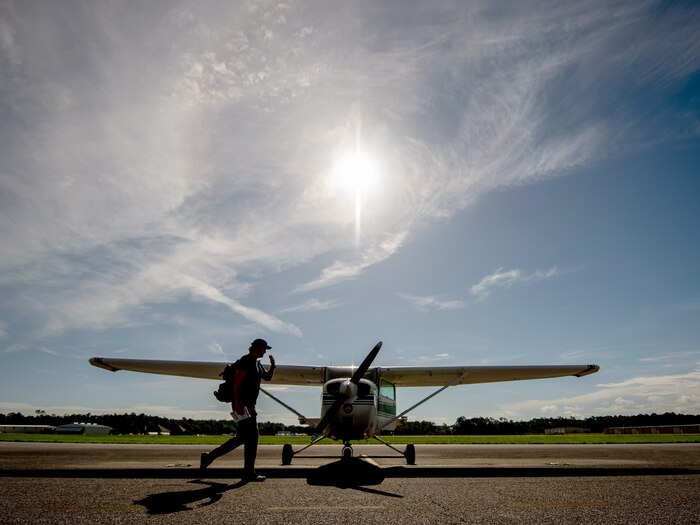 Photo of an AIM HIGH Flight Academy instructor readies a Cessna 172 aircraft for flight training.