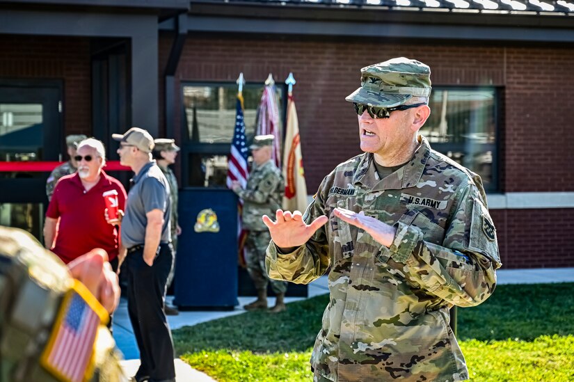 U.S. Army Col. John Wildermann, 99th Readiness Division chief operating officer, speaks to fellow guests at the ASA Fort Dix Aviation Facility ribbon cutting ceremony at Joint Base McGuire-Dix-Lakehurst N.J. on Aug. 19, 2022. The Army Aviation Facility Project was a MILCON effort valued at 11.7 million dollars and made possible through the joint effort of ASA Fort Dix and the U.S. Marine Corps Marine Aircraft Group 49. The 2100 square foot building is host to an Army Ramp Management Area which provides a wide range of capabilities for both fixed and rotary wing aircraft such as the C-130, CH-47S, and UH-60S. The addition of the new Army Ramp will provide enhanced load out and aviation operation training capabilities, parking for Army aviation aircraft, refueling, troop movement and flight planning operations for approximately 216,000 people that use JB MDL to meet readiness requirements.