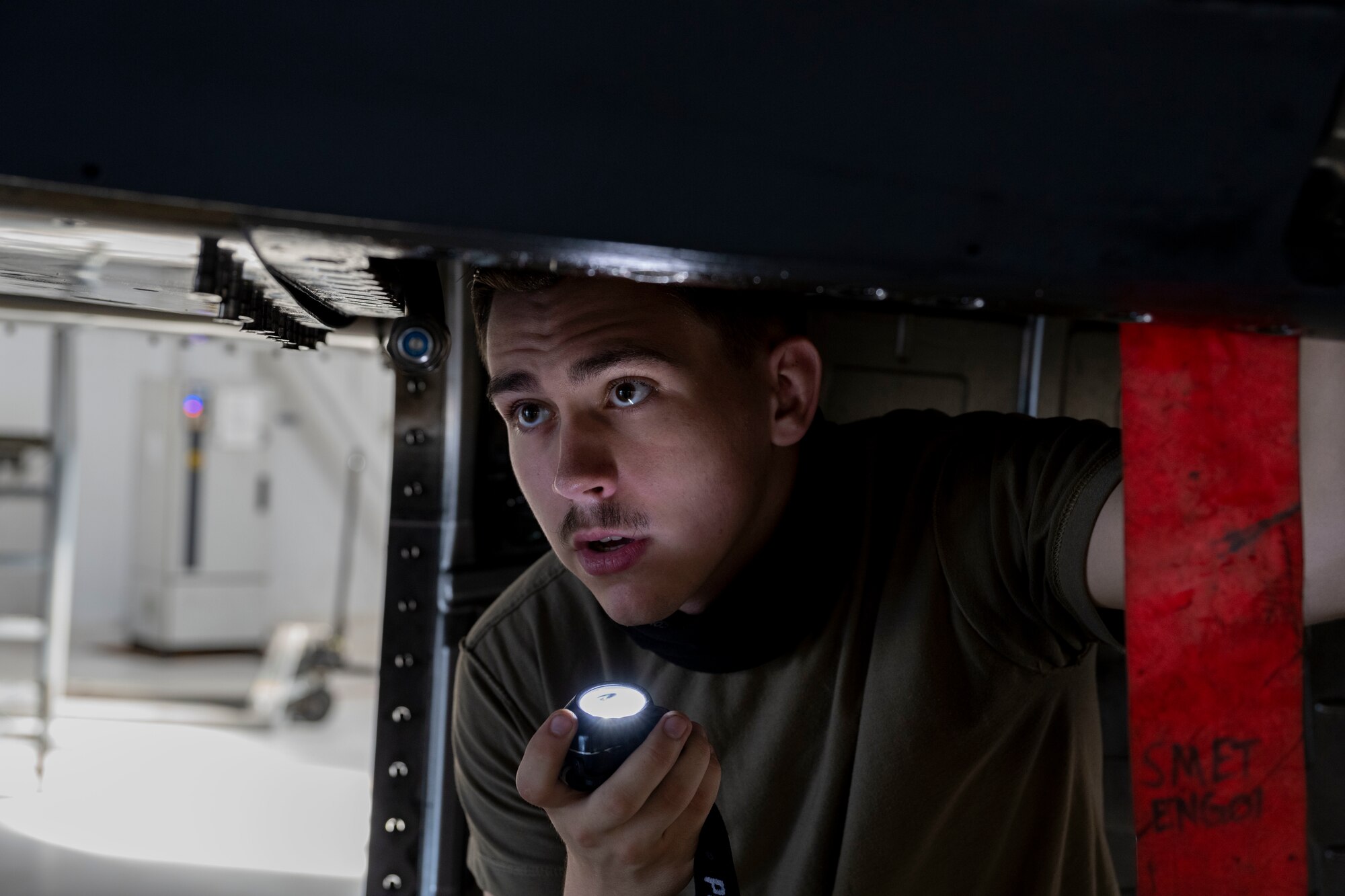 Airman 1st Class Garrett Loeschen, 4th Component Maintenance Squadron electrical and environmental journeyman, examines parts of the F-15E Strike Eagle’s electrical systems at Seymour Johnson Air Force Base, North Carolina, Aug. 9, 2022. Visual inspections of an aircraft’s electrical system ensures that all wires are placed correctly and serviceable prior to function testing. (U.S. Air Force photo by Senior Airman Kevin Holloway)
