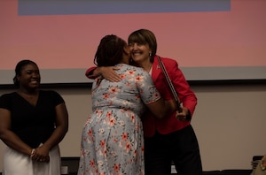 Mrs. Nikki Ray, 92nd Maintenance Squadron spouse, hugs Cathy McMorris Rodgers, U.S. Representative, after receiving an award during the Military Family Life Caucus at Fairchild Air Force Base, Washington, August 17, 2022. The caucus summit went over basic allowance increases, diversity, equity, and inclusion, the exceptional family member program, childcare, and base allowance for housing. (U.S. Air Force photo by Tech Sgt. Heather Clements)