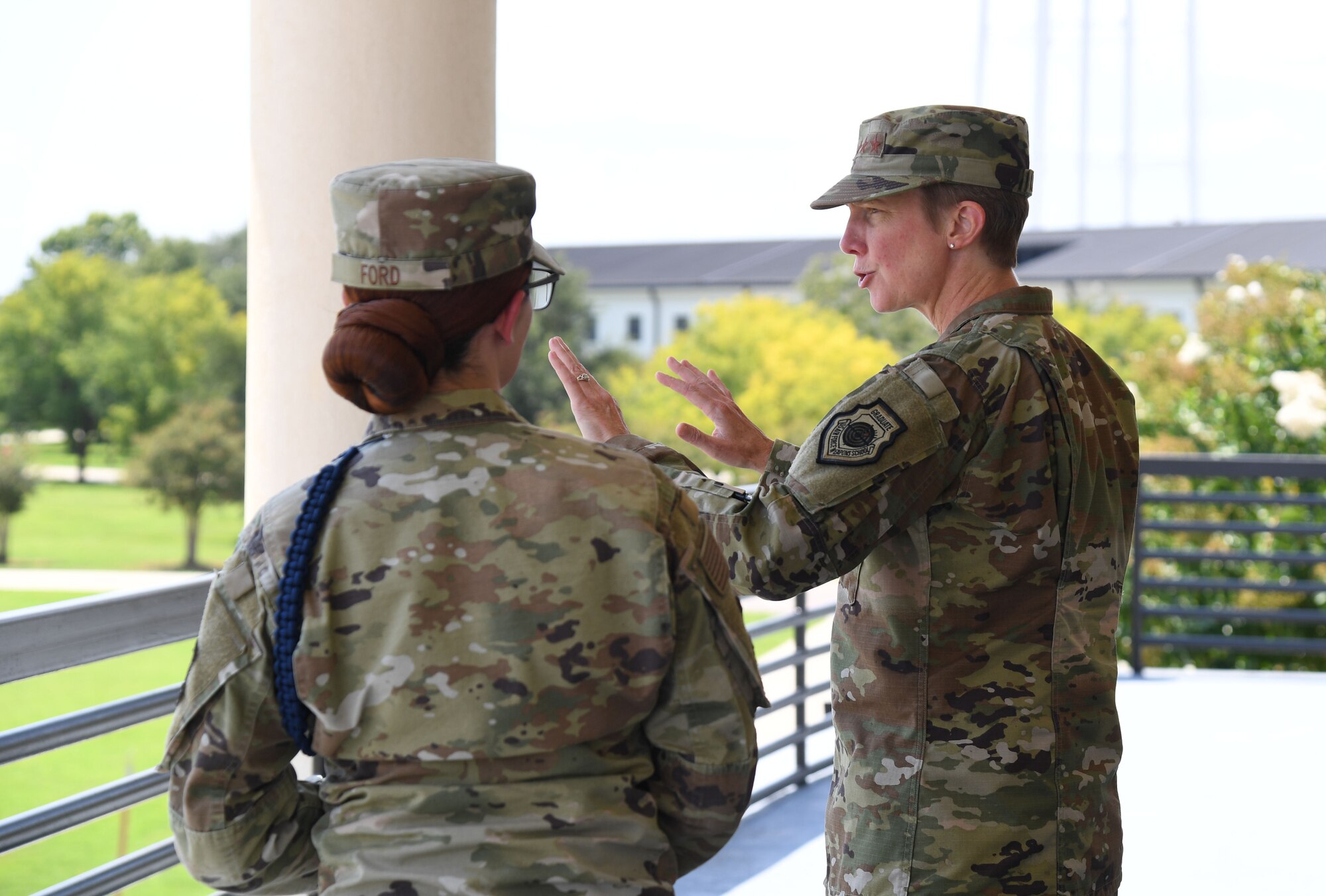 U.S. Air Force Tech. Sgt. Megan Ford, 81st Training Group military training leader, provides an overview of the dorm area to Lt. Gen. Leah Lauderback, Deputy Chief of Staff for Intelligence, Surveillance, Reconnaissance and Cyber Effects Operations, Headquarters U.S. Air Force, the Pentagon, Arlington, Virginia, on the balcony of the Levitow Training Support Facility at Keesler Air Force Base, Mississippi, August 15, 2022. Lauderback and her team also toured the 333rd Training Squadron and 336th Training Squadron to meet and greet squadron personnel, understand the squadron's mission and be briefed on new innovations. (U.S. Air Force photo by Kemberly Groue)