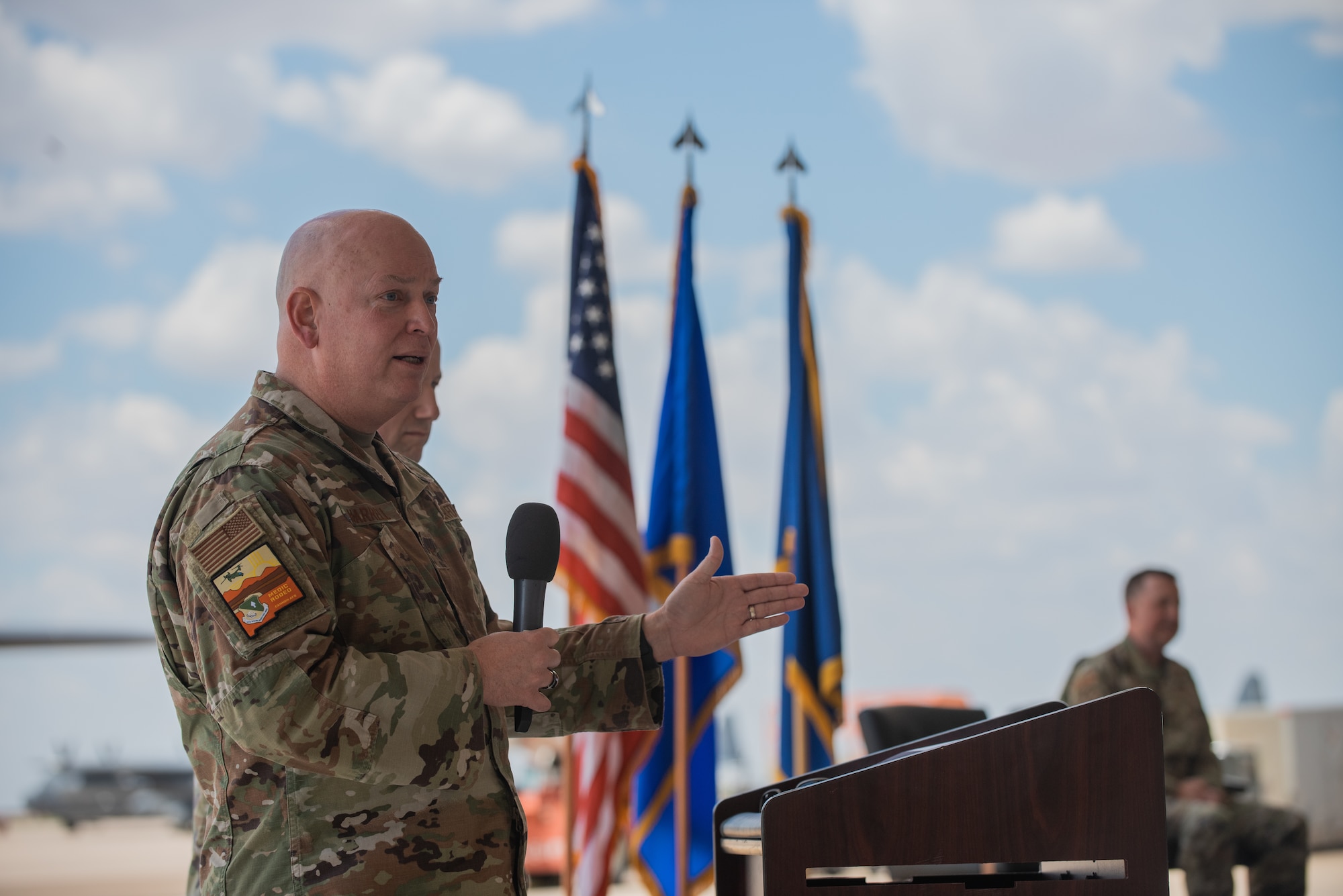 U.S. Air Force Brig. Gen. Thomas W. Harrell, Air Force Medical Readiness Agency commander, speaks at the Medic Rodeo 2022 competition opening ceremony  hosted at Cannon Air Force Base, N.M., Aug. 15, 2022. The 27th Special Operations Wing hosted the 13th iteration of Medic Rodeo; this year incorporated the MEDIC-X initiative which organizes, trains and equips medics to create a more agile, multi-proficient, and interoperable force, capable of accomplishing tasks outside of their core Air Force specialties. (U.S. Air Force photo by Airman 1st Class Mateo Parra)