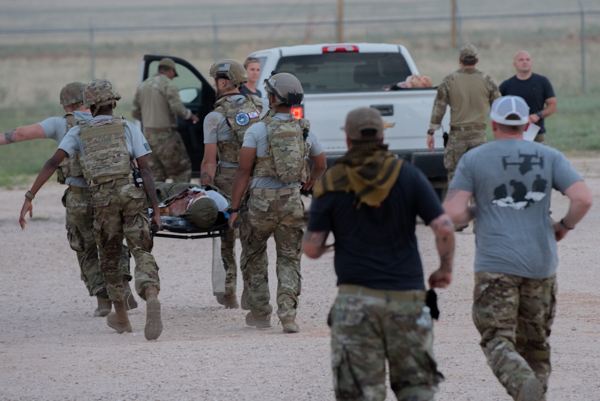 U.S. Air Force medical technicians from Mountain Home Air Force Base, Idaho, rush their stabilized victim to an extraction vehicle during a point of injury exercise as part of the Medic Rodeo 2022 competition at Melrose Air Force Range, N.M., Aug. 17, 2022. Medic Rodeo 2022 incorporates MEDIC-X in scenarios for teams to test the new concept, while evaluating how best to prepare for future warfare where medics have to operate in degraded and geographically isolated environments. (U.S. Air Force photo by Airman 1st Class Mateo Parra)