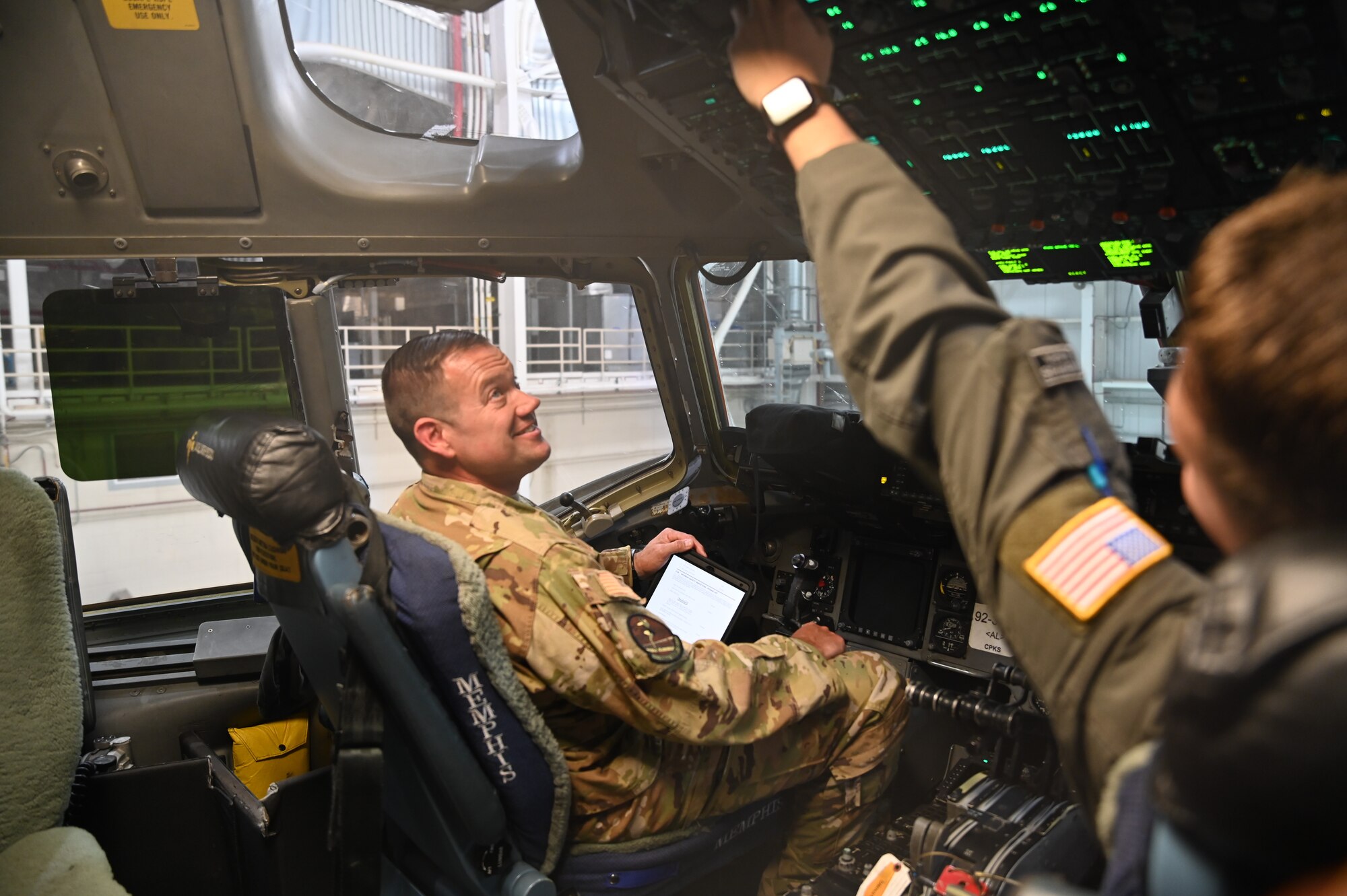 Tech Sgt Brett Yoakum , a loadmaster with the 155th Airlift Squadron, demonstrates different duties of his job in a C-17 Globemaster III at the 164th Airlift Wing in Memphis, Tenn. May 15, 2022. Yoakum was recently awarded the Outstanding Airman of the Year Award for his hard work flying multiole missions wit the 164th Operations Group. 
(U.S. Air National Guard photo by Airman 1st Class TràVonna Hawkins)