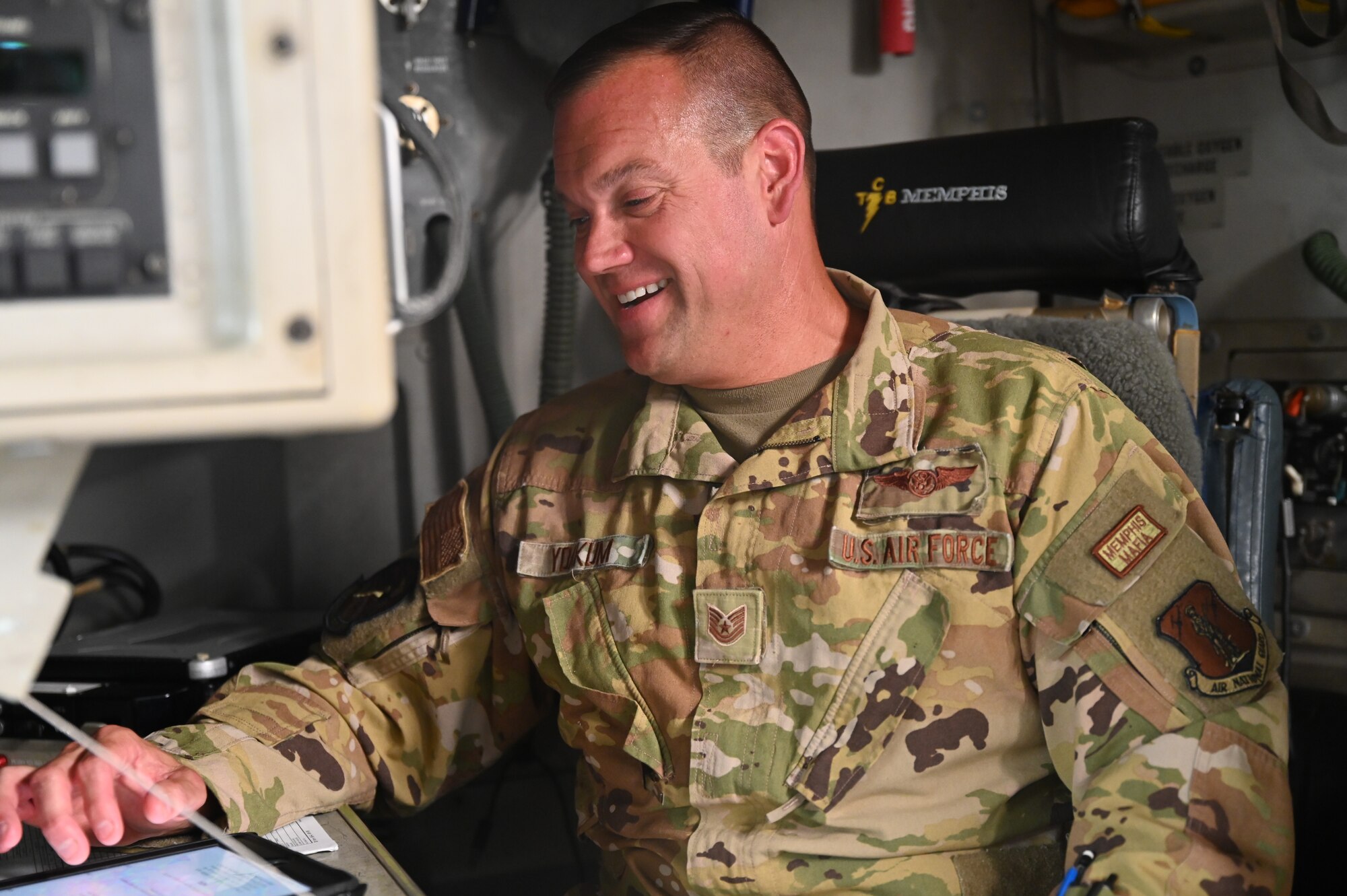 Tech Sgt Brett Yoakum , a loadmaster with the 155th Airlift Squadron, demonstrates different duties of his job in a C-17 Globemaster III at the 164th Airlift Wing in Memphis, Tenn. May 15, 2022. Yoakum was recently awarded the Outstanding Airman of the Year Award for his hard work flying multiole missions wit the 164th Operations Group. 
(U.S. Air National Guard photo by Airman 1st Class TràVonna Hawkins)