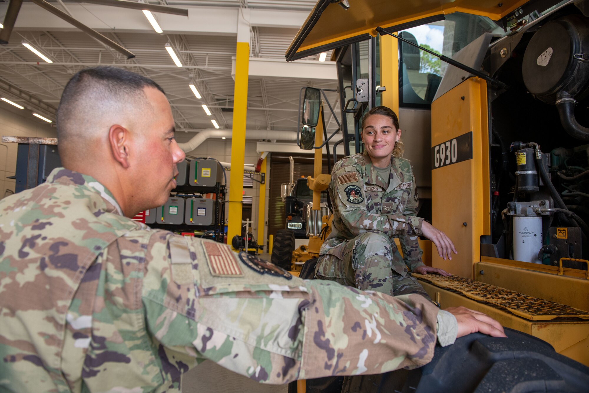 U.S. Air Force Senior Master Sgt. Jonathan Sotomayor, 1st Sgt. of the 202nd Rapid Engineer Deployable Heavy Operational Repair Squadron Engineers, or RED HORSE, Florida Air National Guard, discusses maintenance repairs on a vehicle with U.S. Air Force Airman 1st Class Cheyenne Hodges, a 202nd RHS vehicle maintainer, at the squadron's headquarters located at Camp Blanding Joint Training Center in Starke, FL, July 6, 2022. Sotomator was named the 2022 Outstanding 1st Sgt. of the Year for the Air National Guard and will be recognized during the ANG's Focus on the Force week in August 2022. (U.S. Air National Guard photo by Tech. Sgt. Chelsea Smith)