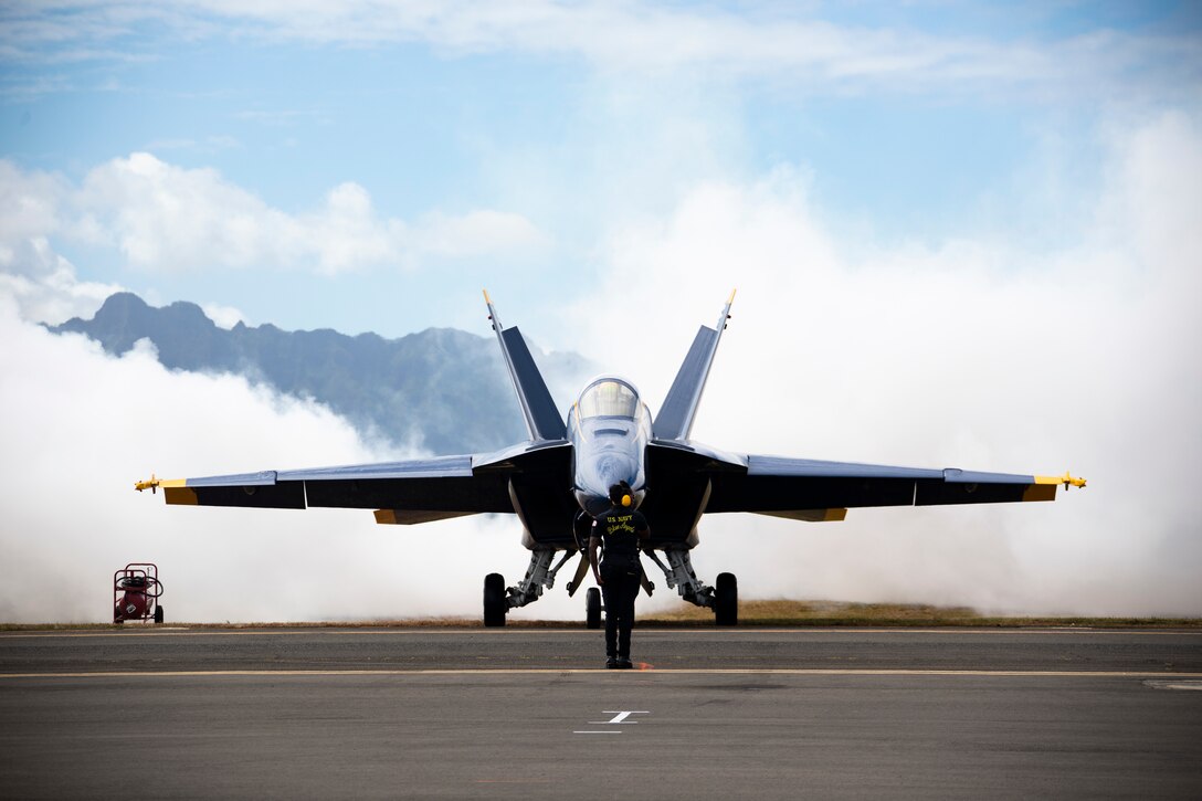 Maintenance crew members with the U.S. Naval Flight Demonstration Squadron, The Blue Angels, prepare to take off as part of the 2022 Kaneohe Bay Air Show, Marine Corps Air Station Kaneohe Bay, Marine Corps Base Hawaii, Aug. 14, 2022. The air show provided an opportunity for MCBH to foster positive relationships with the local community, while providing a unique experience to the public. The Kaneohe Bay Air Show, which contained aerial performances, static displays, demonstrations and vendors, was designed to express MCBH’s appreciation to the residents of Hawaii and their continued support of the installation. (U.S. Marine Corps photo by Cpl. Samantha Sanchez)