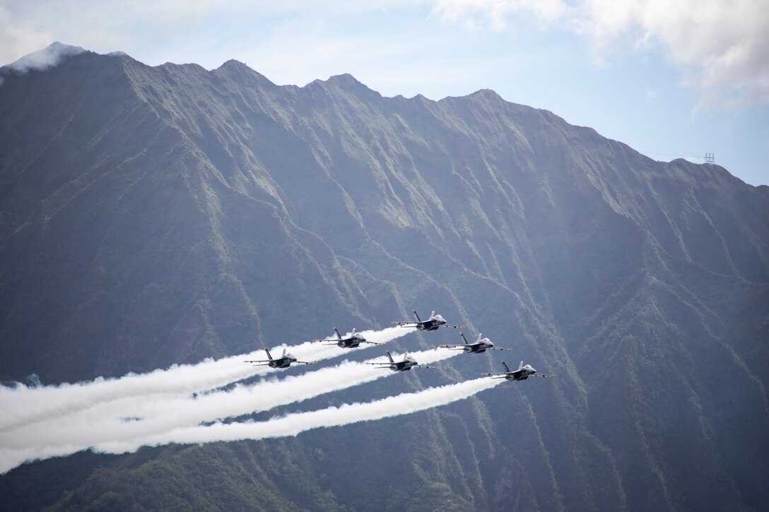 The U.S. Naval Flight Demonstration Squadron, The Blue Angels, perform flight demonstrations in F/A-18 Super Hornets as part of the 2022 Kaneohe Bay Air Show, Marine Corps Air Station Kaneohe Bay, Marine Corps Base Hawaii, Aug. 14, 2022. The air show provided an opportunity for MCBH to foster positive relationships with the local community, while providing a unique experience to the public. The Kaneohe Bay Air Show, which contained aerial performances, static displays, demonstrations and vendors, was designed to express MCBH’s appreciation to the residents of Hawaii and their continued support of the installation. (U.S. Marine Corps photo by Cpl. Samantha Sanchez)