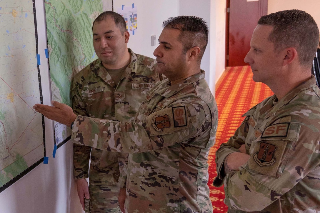 Technical Sgt. Christopher Gonzales (center) discusses areas of responsibility with Staff Sgt. Matthew Ong and Maj. Jeff Robertson, during U.S. Central Command’s Exercise REGIONAL COOPERATION 22 in Dushanbe, Tajikistan. At home station in Phoenix, Arizona, Maj. Robertson is the 161st Security Forces Squadron (161 SFS) commander, and Ong and Robertson are 161 SFS Defenders. (U.S. Air National Guard photo by Maj. Angela Walz)