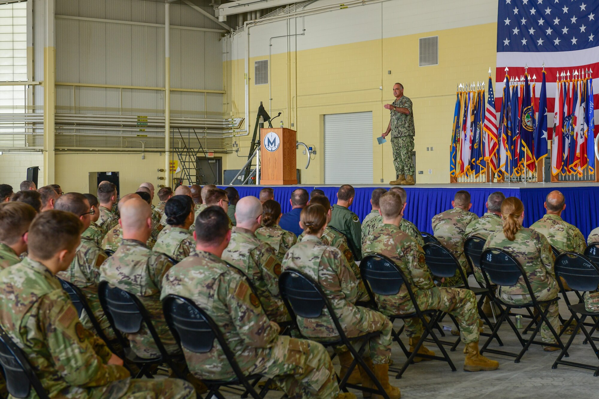 Adm. Charles Richard, United States Strategic Command commander, speaks at an all-call on Minot Air Force Base, North Dakota, Aug. 18, 2022. During the all call, Adm. Richard stressed the importance of Minot AFB providing two legs of the nation's nuclear triad, while answering questions from Airmen. (U.S. Air Force photo by Airmen Alysa Knott)