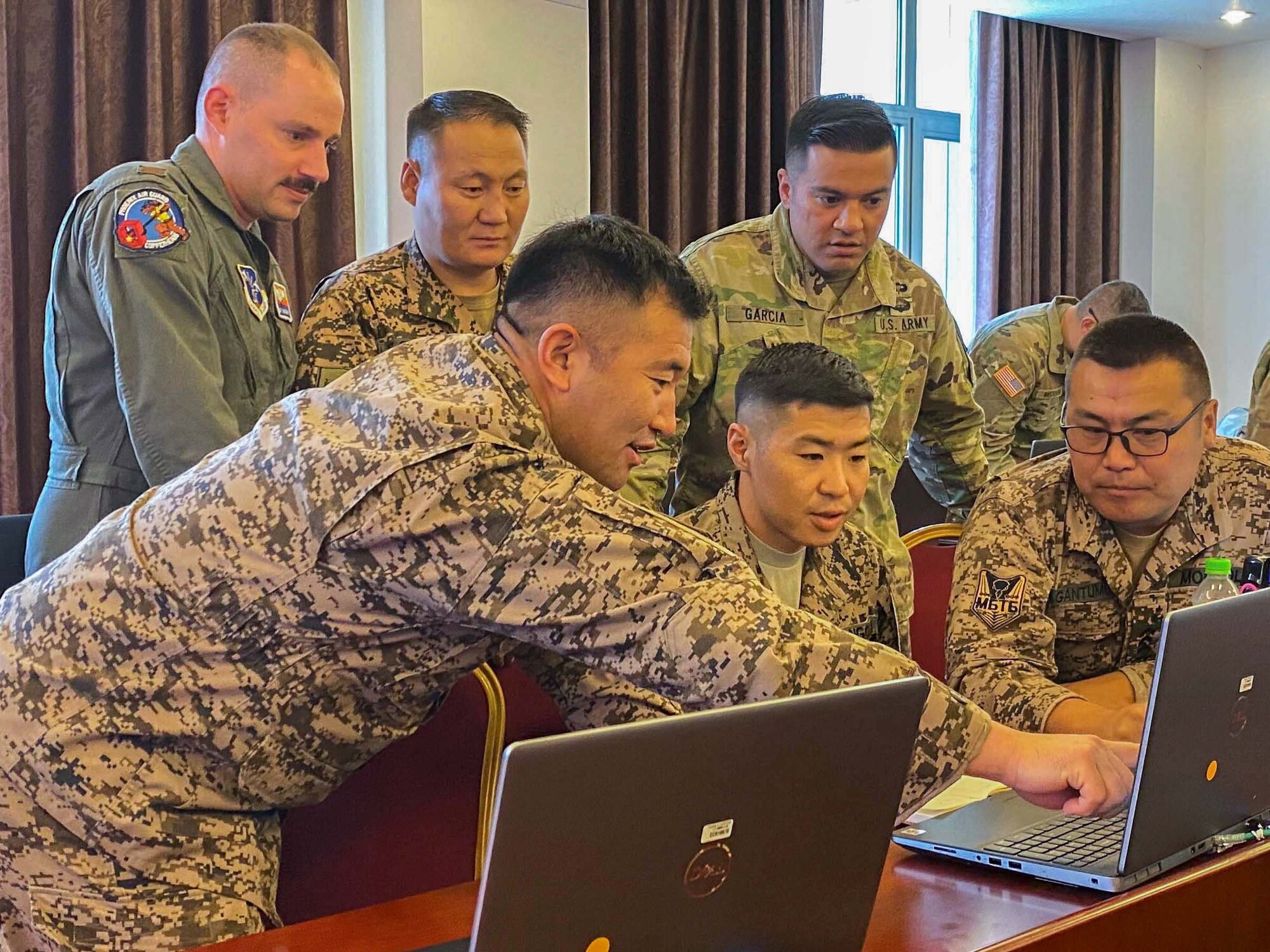 Arizona Air National Guard Second Lieutenant Phillip Haugan, left (in flight suit) a KC-135 pilot with the 161st Air Refueling Wing, participated in U.S. Central Command’s Exercise REGIONAL COOPERATION 22 in Dushanbe, Tajikistan, as an aviation operations officer, and coordinated flight planning with partner nations, including Tajikistan, Kazakhstan, Kyrgyz Republic, Mongolia, Pakistan, and Uzbekistan. (U.S. Army National Guard photo by Maj. Phil Blanchard)