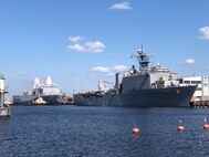 The Whidbey Island-class dock landing ship USS Gunston Hall (LSD 44), right, and San Antonio-class amphibious transport dock ship USS Arlington (LPD 24) sit pierside in Riga, Latvia during a scheduled port visit, Aug. 20, 2022.