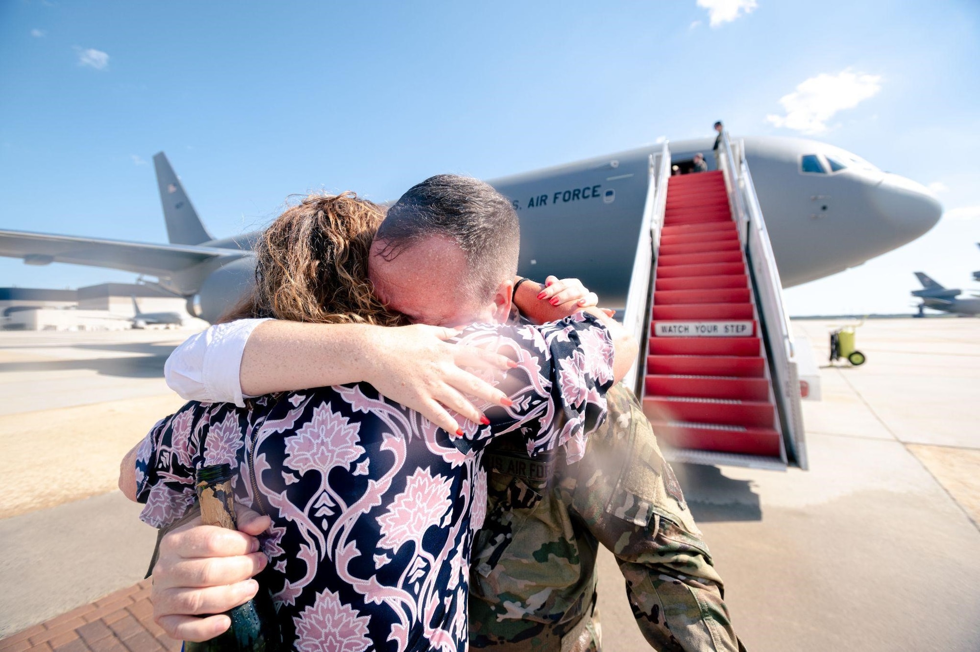Man hugs woman