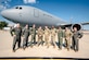 A group of military members stand in front of a KC-46A Pegasus